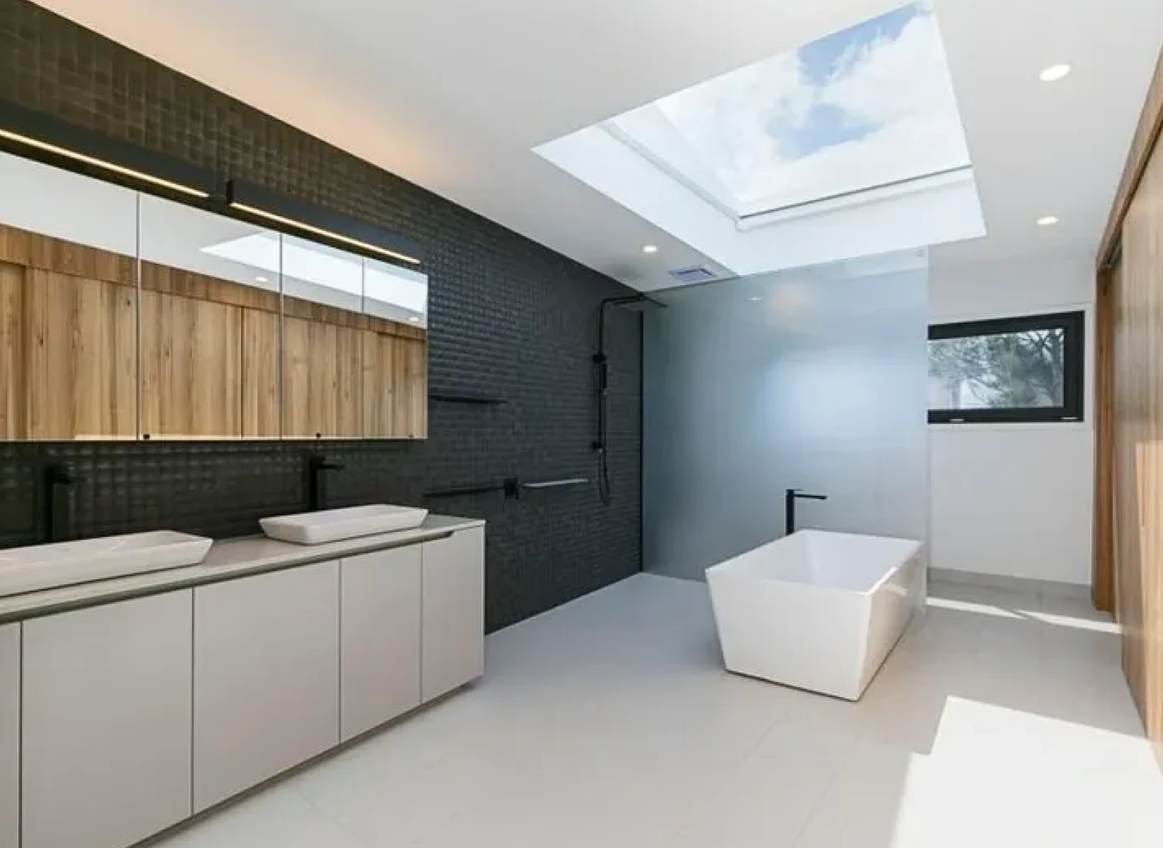 Spacious bathroom featuring black and white decor