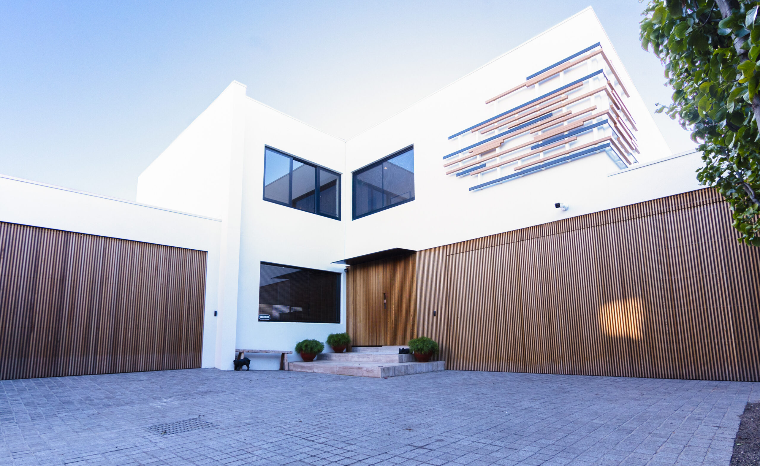 Modern white house with wooden garage doors