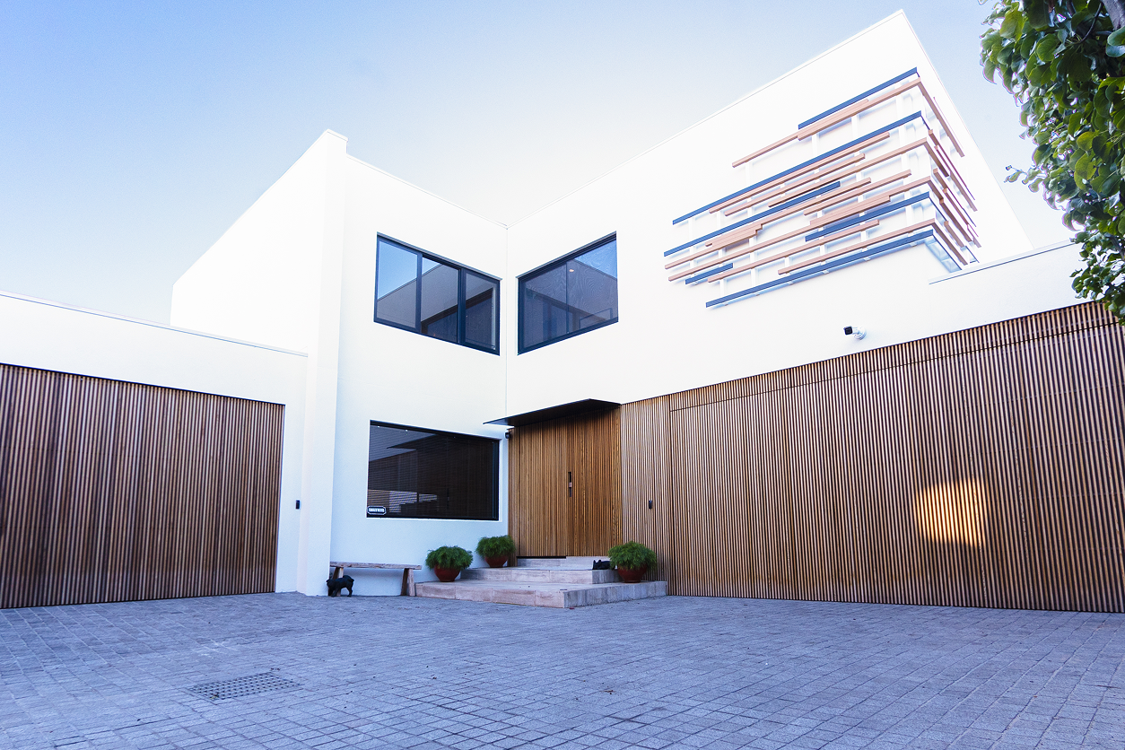 Modern white house with wooden slatted facade