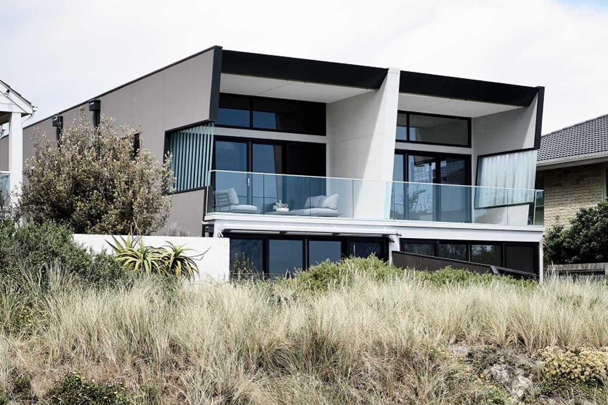 Modern beachfront house with glass balcony